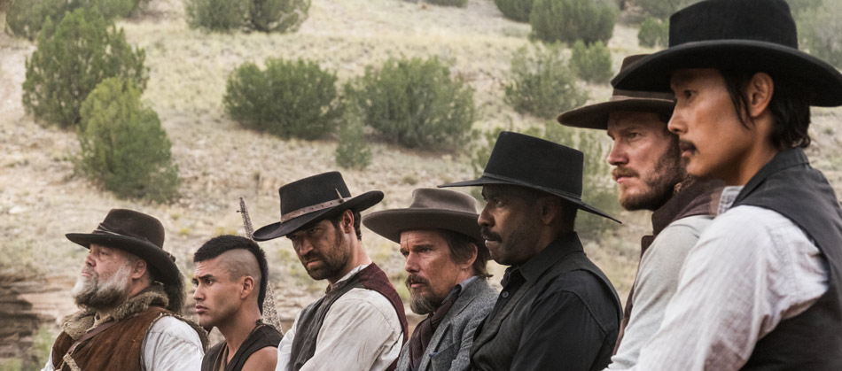 A still of the Magnificent Seven lined up in a shot from the film.