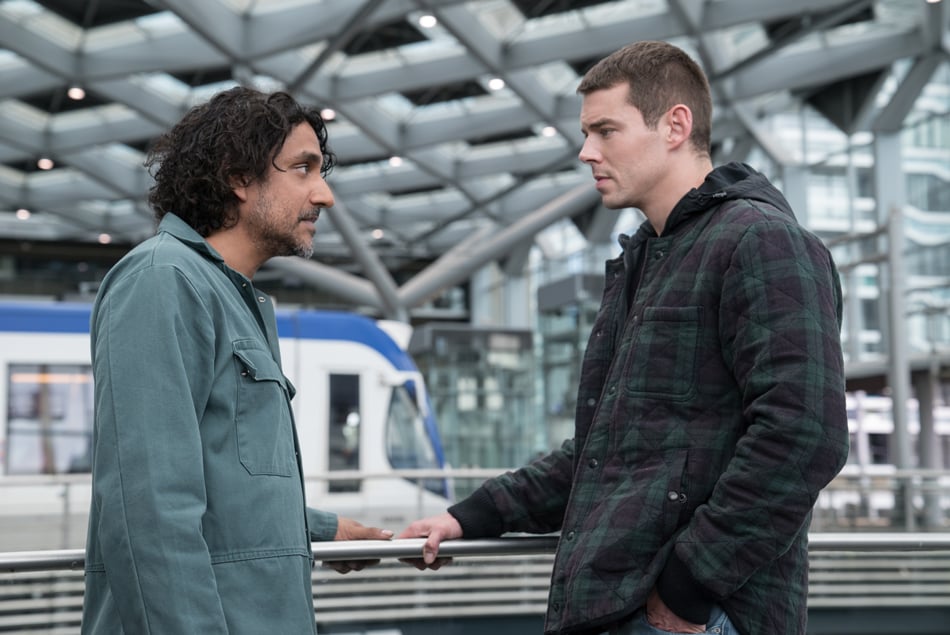Naveen William and Brian J. Smith talking inside of a train station from Sense8